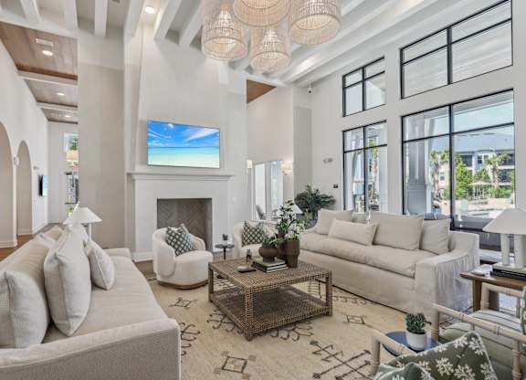 A living room with a fireplace and a large screen TV.