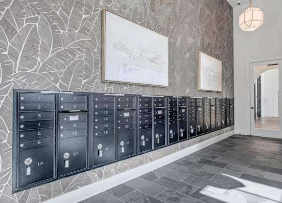 A row of mailboxes are lined up against a wall.