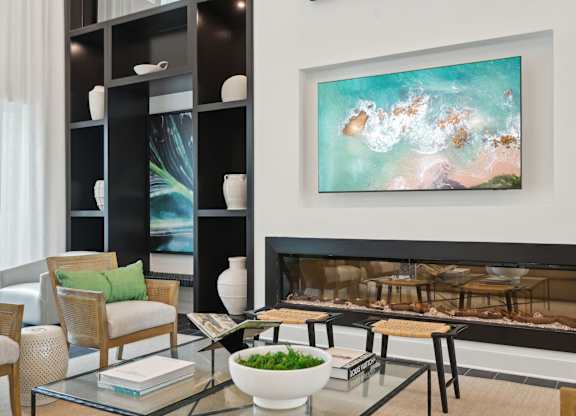 Luxury leasing center and clubhouse with modern fireplace at Tapestry University Park in Sarasota, FL