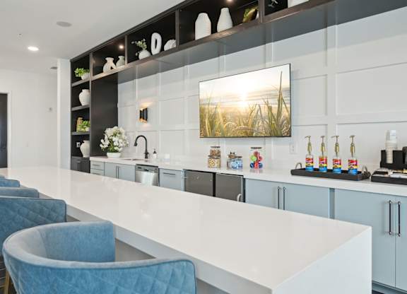 Clubhouse kitchen with large island, full kitchen, and TV at Tapestry University Park in Sarasota, FL