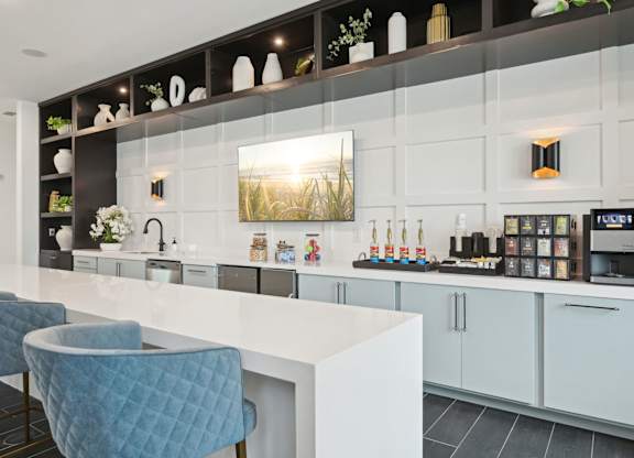 Modern clubhouse kitchen with stocked coffee bar at Tapestry University Park in Sarasota, FL