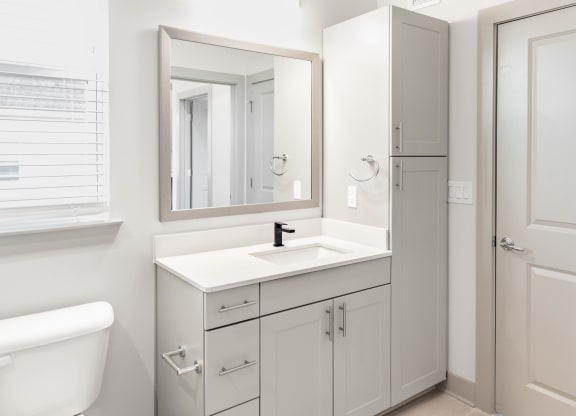 a bathroom with modern fixtures, linen cabinet, and storage at Anthem Luxury Rentals and Apartment Homes and Cottages