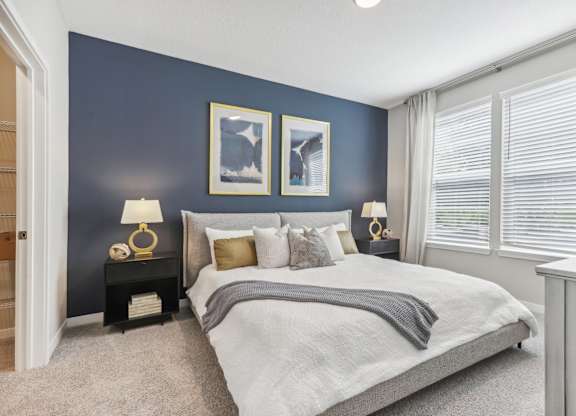 the preserve at ballantyne commons bedroom with blue accent wall and large windows
