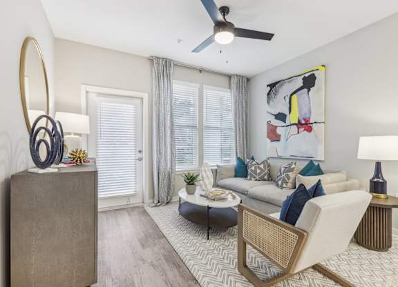 a living room with a couch and a ceiling fan