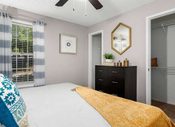 Carpeted bedroom with ceiling fan, and large closets at Summerchase at Riverchase in Hoover, Alabama