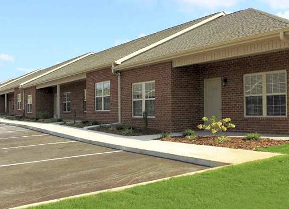 Apartment building with private front porch at Breckenridge Apartments in Tuscumbia, AL