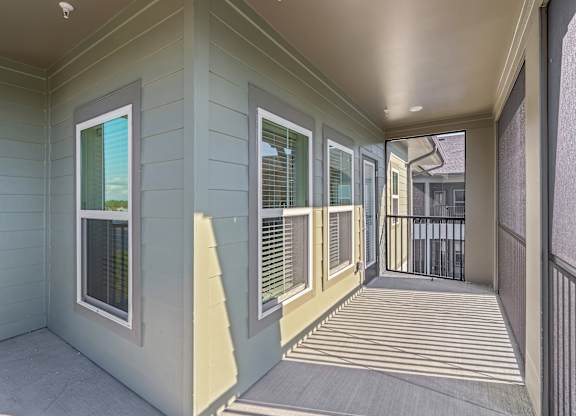 A balcony with a railing and a view of a building.