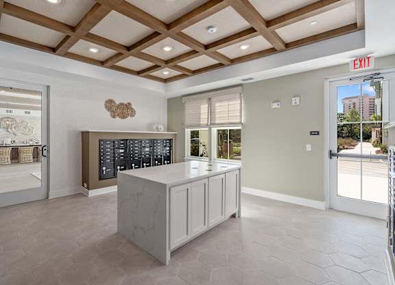 A modern kitchen with a large island and a view of the outdoors.