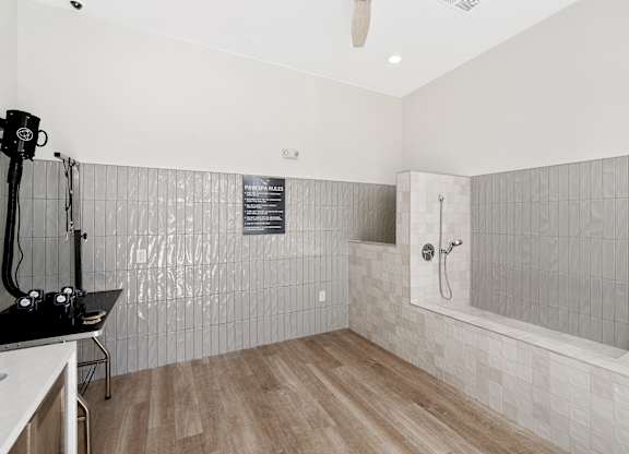 A bathroom with a shower and a sink.