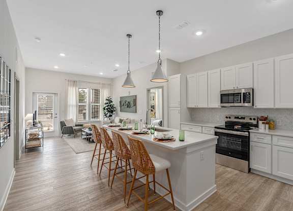 A modern kitchen with a dining table and chairs.