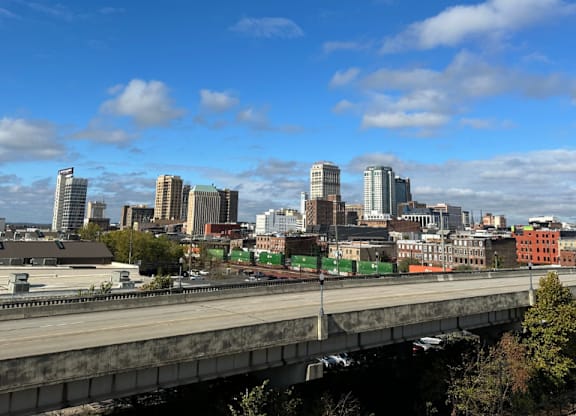 A cityscape view from the Fitzroy Apartments with a bridge in the foreground and downtown skyline in Birmingham Alabama.