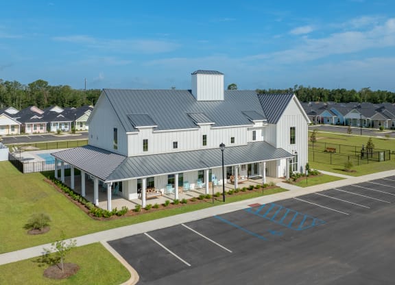 an aerial view of a building with a parking lot at The Cottages at Foley Farms apartments in Foley, AL