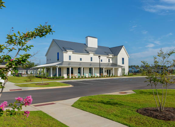 a large white house with a street in front of it at The Cottages at Foley Farms apartments in Foley, AL