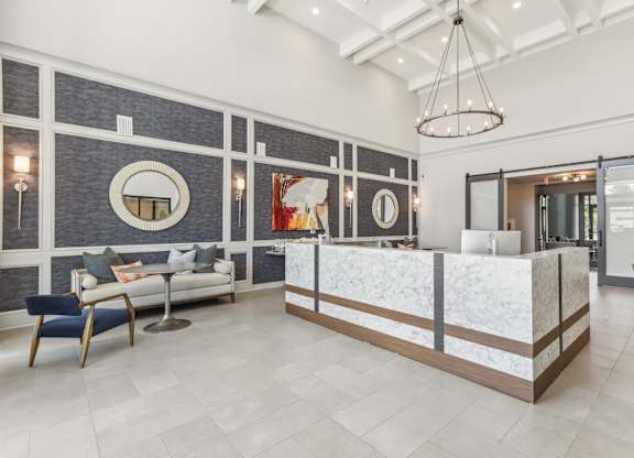 a lobby with a reception desk and a couch