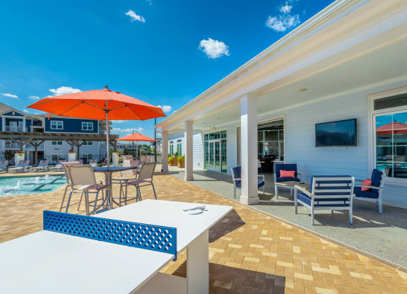 pool seating, ping pong, and sundeckat Anthem Apartments and Cottages in Huntsville, Alabama