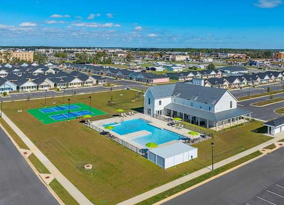 A large building with a pool in front of it.