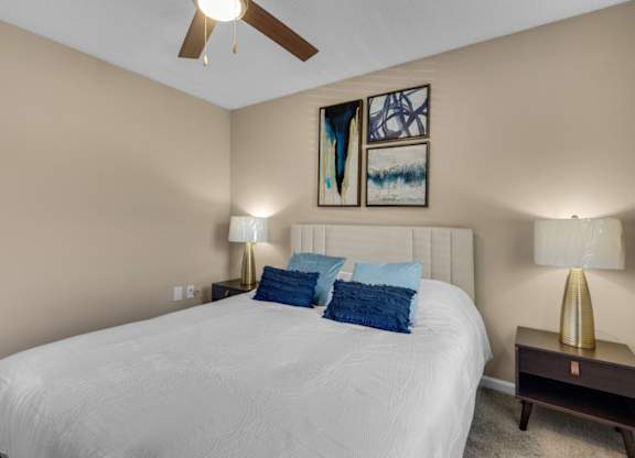 A bedroom with carpet flooring and ceiling fan at Crystal Lake in Pensacola, Florida.