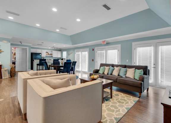 Clubhouse with an open floorplan including lounge areas and a community kitchen at Crystal Lake in Pensacola, Florida.