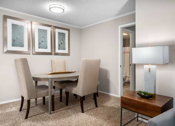 Carpeted dining room with modern lighting at Summerchase at Riverchase in Hoover, Alabama