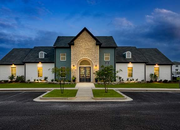 a house with a dark blue sky in the background
