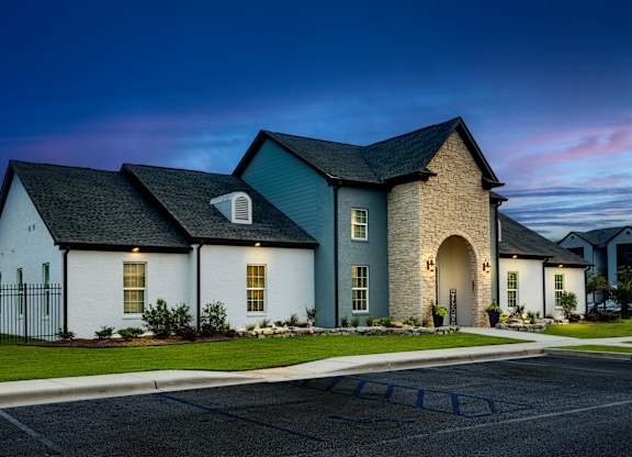 a home with a dark blue roof and white walls