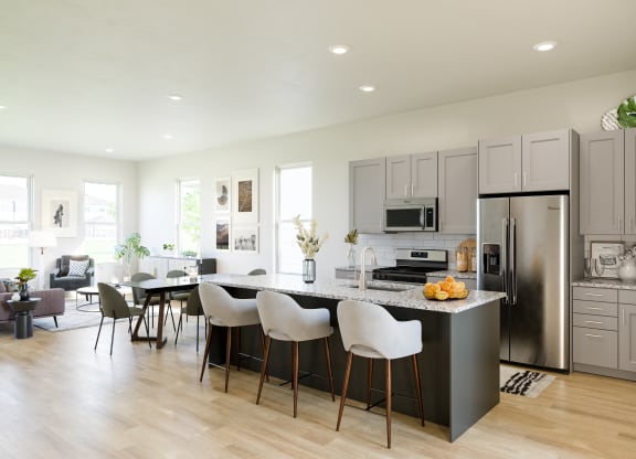 open concept kitchen with gray cabinets and a large island at Anthem Apartments and Cottages in Huntsville, Alabama