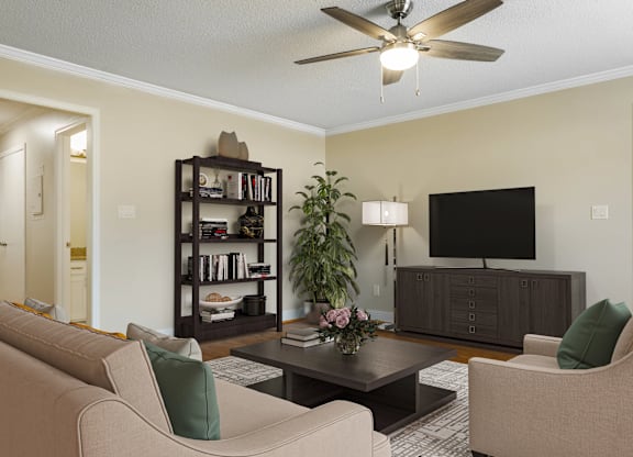 A living room with a beige couch, a black bookshelf, a coffee table, and a flat-screen TV.