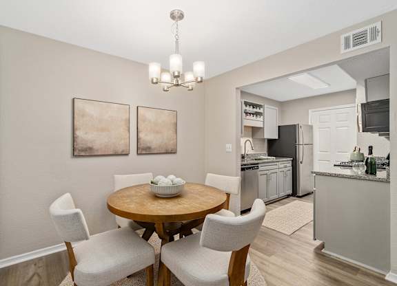 A dining room with a table set for two.
