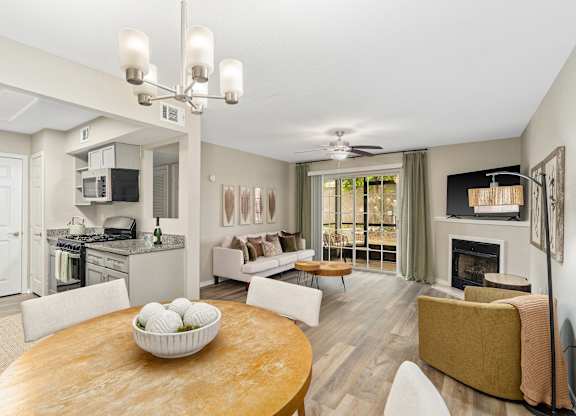 A modern living room with a fireplace and a dining table.