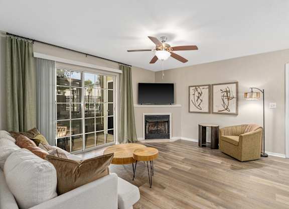 A living room with a fireplace and a flat screen TV.
