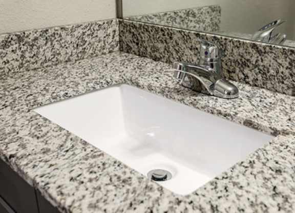 Granite countertops with undermount sinks and upgraded hardware at Avia Apartments in Vestavia Hills, AL
