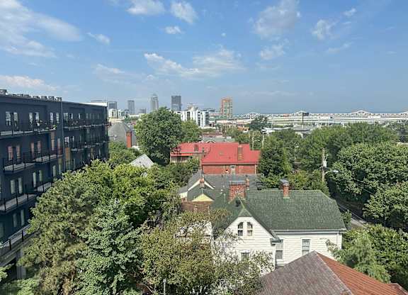 an aerial view of the city of minneapolis with a few houses and trees in the foreground