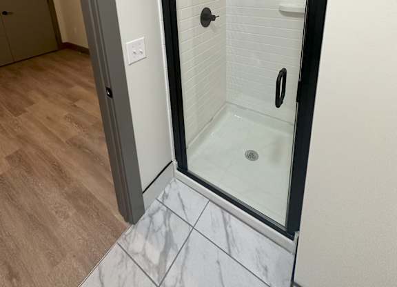 a walk in shower in a 555 waverly unit