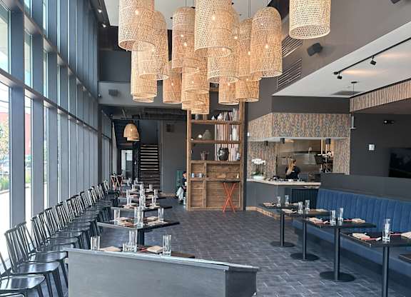 a restaurant with a long dining room with many tables and chairs