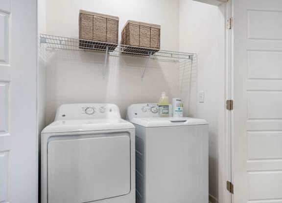 A white washing machine and dryer in a small laundry room.
