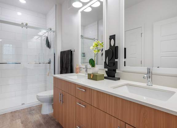 A bathroom with a white sink and a mirror.