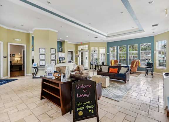a large living room with a chalkboard sign in the middle