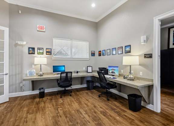 a home office with two desks and two computers