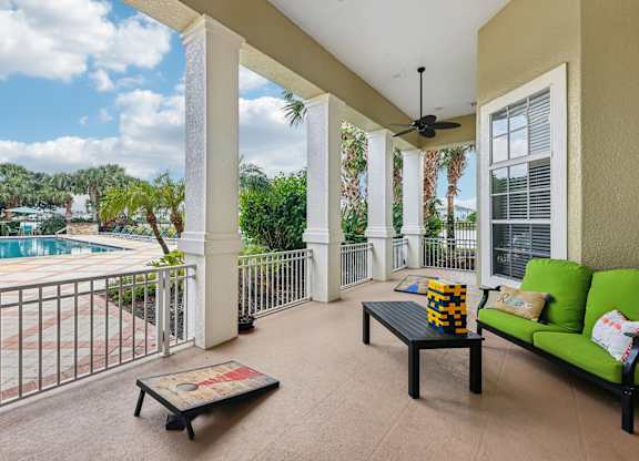 a balcony with a pool and a couch and a coffee table
