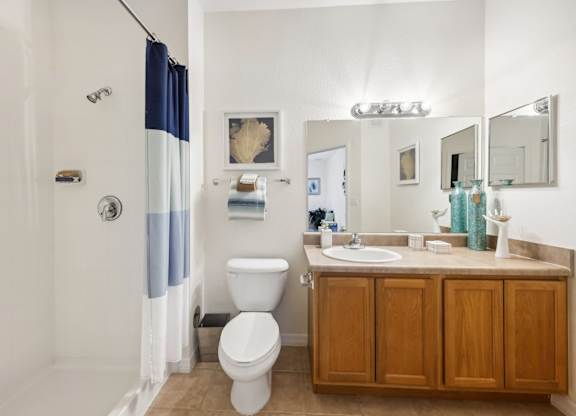 a bathroom with a toilet and a sink and a shower