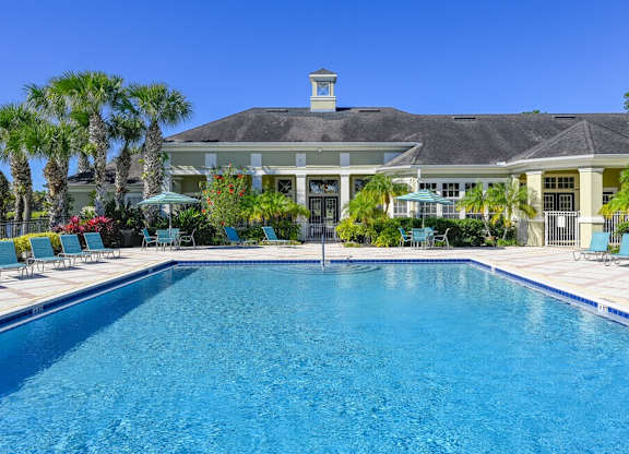 a large swimming pool in front of a house