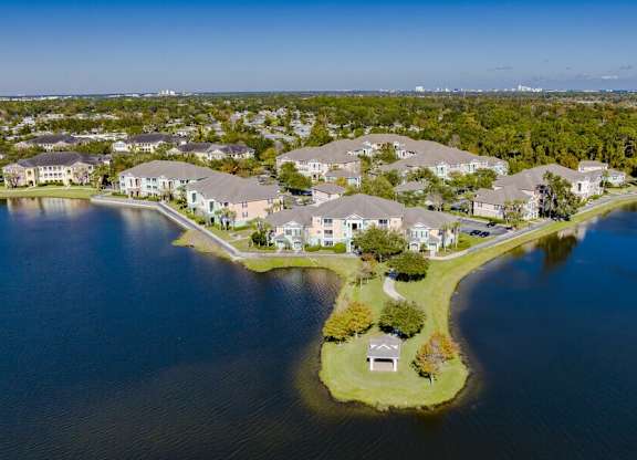 an aerial view of houses on the water near a lake