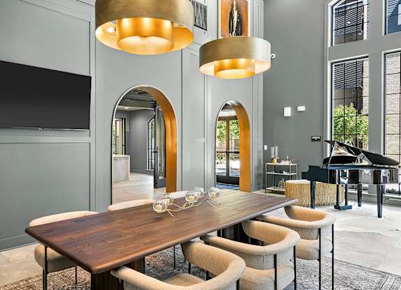 A modern dining room with a wooden table and chairs.