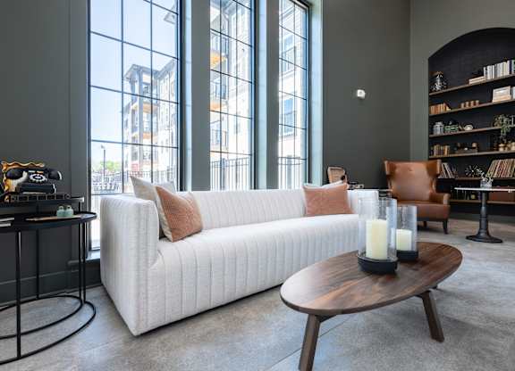 A modern living room with a white sofa and a coffee table.