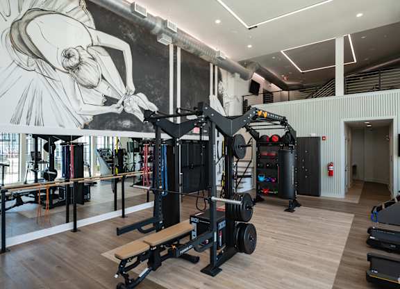 A gym with a mural of a woman on the wall.
