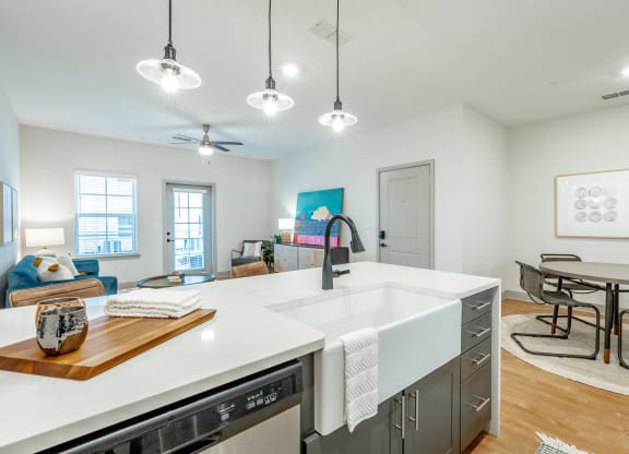 luxe amenity package with farmhouse sink, gooseneck faucet, and pendant lighting cottage open floor plan with luxe amenity package at Anthem Apartments and Cottages in Huntsville, Alabama