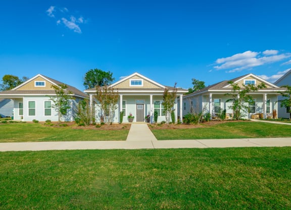 a home with a green lawn and a blue sky