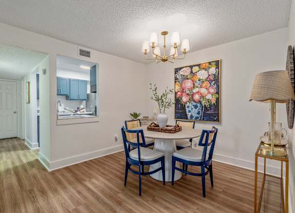 A dining room with a table set for four.
