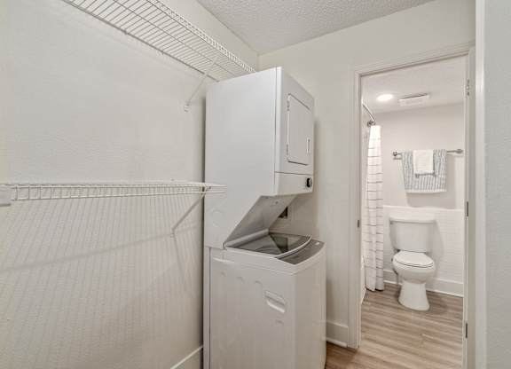 A white laundry room with a washer and dryer.