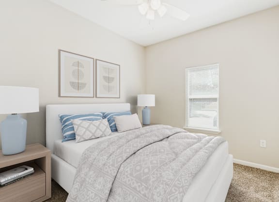 A bedroom with a bed, nightstand, and two framed pictures on the wall.